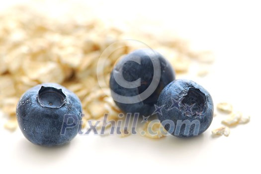 Blueberries and oats macro on white background Blueberries and oats macro on white background