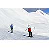 Couple snowboarding on the backdrop of scenic view in Canadian Rocky mountains ski resort