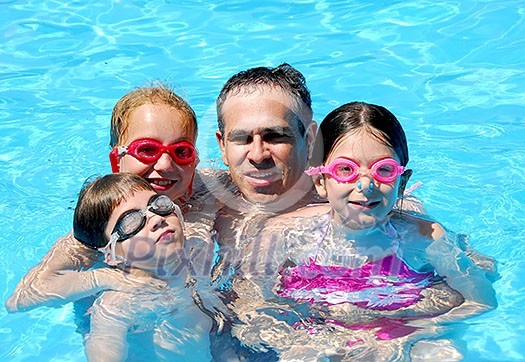 Family having fun in swimming pool Family having fun in swimming pool
