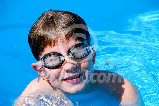 Cute little boy having fun in a swimming pool Cute little boy having fun in a swimming pool