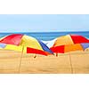 Two beach ubrella standing on ocean shore