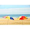 Two beach ubrella standing on ocean shore