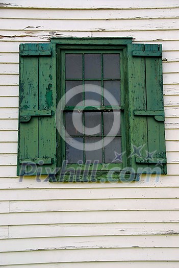 Window with shutters on old mill building Window with shutters on old mill building