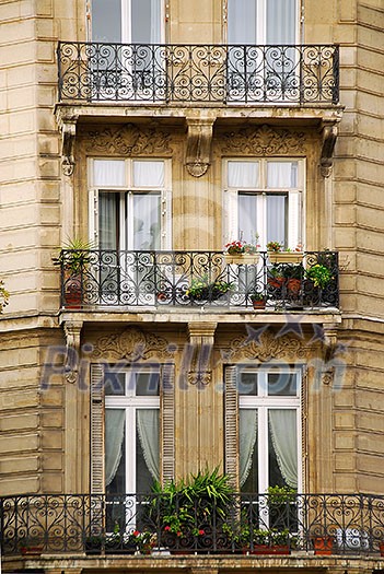 Windows and balconies of old apartment buildings in Paris France Windows and balconies of old apartment buildings in Paris France