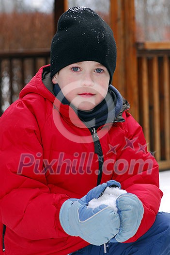 Portrait of a boy making a snowball in winter park Portrait of a boy making a snowball in winter park