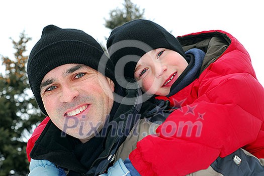 Portrait of father and son playing in winter park Portrait of father and son playing in winter park