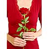 Woman in red holding a red rose