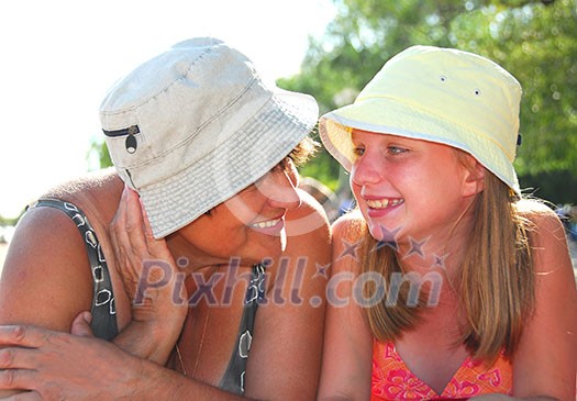 Portrait of grandmother and granddaughter lying on a sandy beach Portrait of grandmother and granddaughter lying on a sandy beach