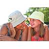 Portrait of grandmother and granddaughter lying on a sandy beach