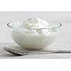 Fresh yogurt served in a clear glass bowl