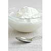 Fresh yogurt served in a clear glass bowl
