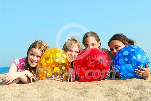 Portrait of four young girls with colorful beach balls Portrait of four young girls with colorful beach balls