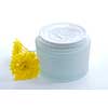 Open jar of a luxury cream with yellow flowers