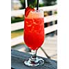 Cold strawberry daiquiri beverage served on an outdoor patio
