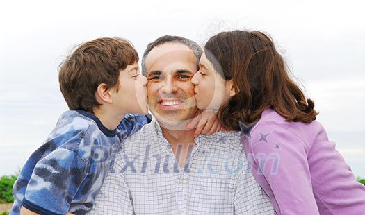 Grateful children giving their father a kiss Grateful children giving their father a kiss