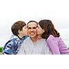 Grateful children giving their father a kiss