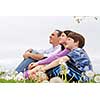 Portrait of a family father and children outside on green grass