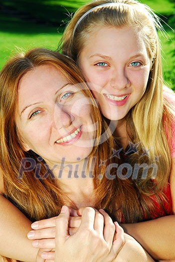 Portrait of mother and daughter in summer park Portrait of mother and daughter in summer park