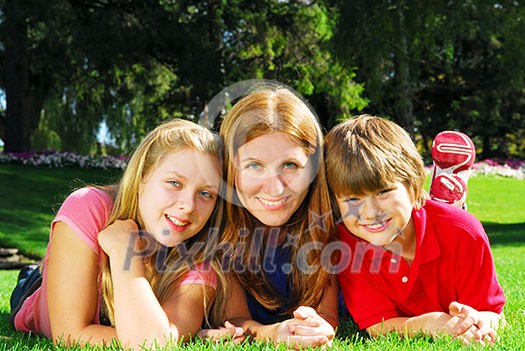 Portrait of a family - mother and children - relaxing in summer park Portrait of a family - mother and children - relaxing in summer park