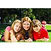 Portrait of a family - mother and children - relaxing in summer park
