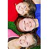 Portrait of a family - mother and children - lying on grass in a park