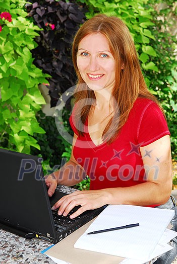 Woman working on her computer at home, small business owner Woman working on her computer at home, small business owner