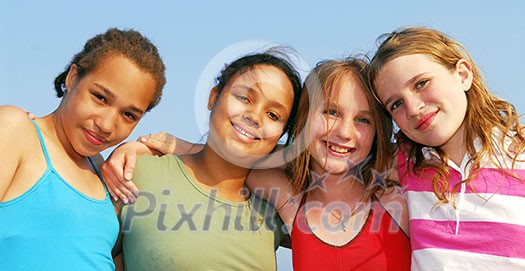 Portrait of four smiling teenage girls outside Portrait of four smiling teenage girls outside