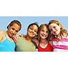 Portrait of four smiling teenage girls outside