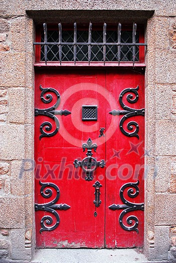 Red medieval door in Mont Saint Michel abbey in France Red medieval door in Mont Saint Michel abbey in France