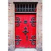 Red medieval door in Mont Saint Michel abbey in France