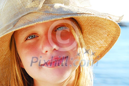 Portrait of a teenage girl wearing straw hat on a beach Portrait of a teenage girl wearing straw hat on a beach