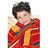 Young boy wrapped in a towel on a beach relaxing after swimming
