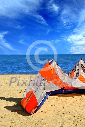 Big kite for kite surfing lying on a sandy beach Big kite for kite surfing lying on a sandy beach
