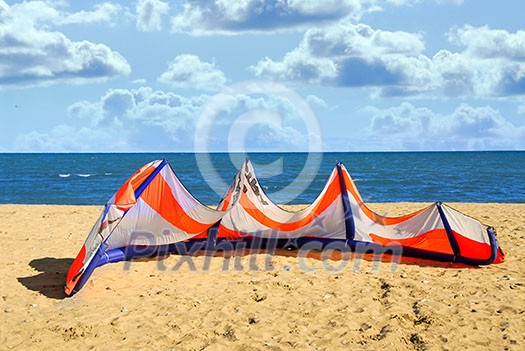 Big kite for kite surfing lying on a sandy beach Big kite for kite surfing lying on a sandy beach