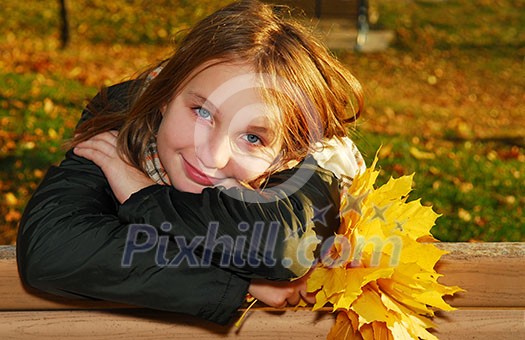 Portrait of a beautiful teenage girl with yellow fall maple leaves Portrait of a beautiful teenage girl with yellow fall maple leaves