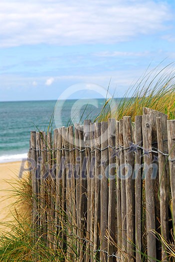 Old wooden fence on a beach in Brittany, France
