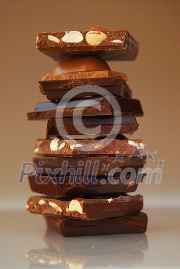 Stack of broken pieces of chocolate from assorted bars Stack of broken pieces of chocolate from assorted bars