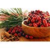 Fresh red cranberries in wooden bowls with spices and pine branches
