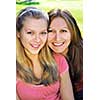 Portrait of a smiling mother and teenage daughter in summer park