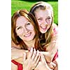 Portrait of a smiling mother and teenage daughter in summer park
