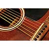 Acoustic guitar bridge and strings close up