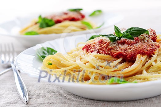 Pasta with tomato sauce basil and grated parmesan