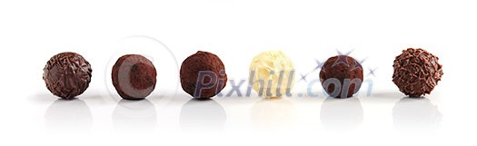 Row of assorted chocolate truffles on white background Row of assorted chocolate truffles on white background