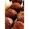 Several assorted gourmet chocolate truffles close up