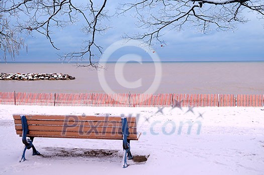 Winter park with a bench covered with snow. Beach area, Toronto, Canada. Winter park with a bench covered with snow. Beach area, Toronto, Canada.