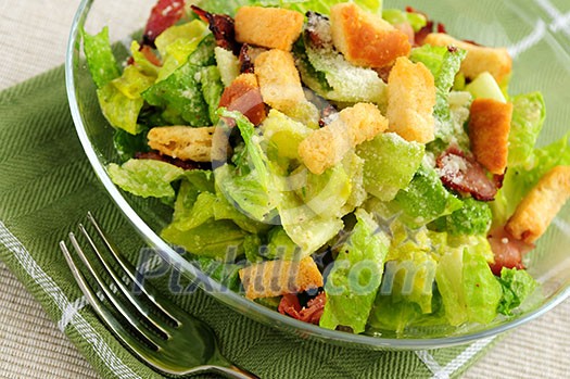 Fresh caesar salad served in a glass bowl Fresh caesar salad served in a glass bowl