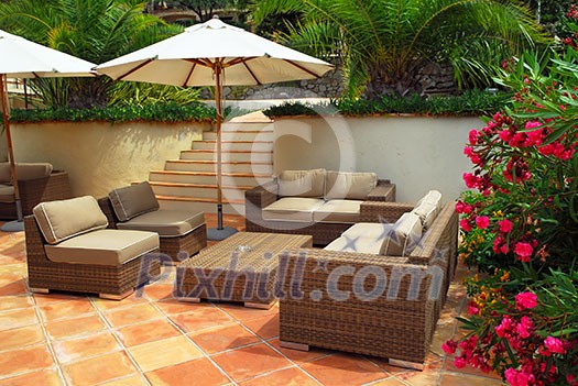 Patio of mediterranean villa in French Riviera with wicker furniture Patio of mediterranean villa in French Riviera with wicker furniture