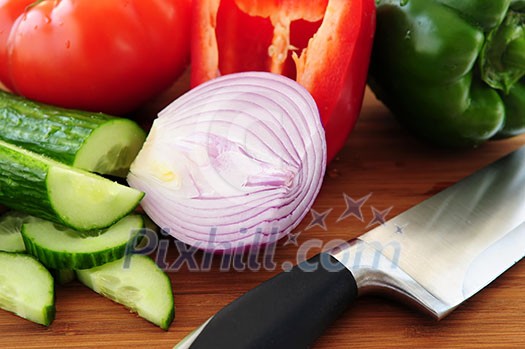 Fresh garden vegetables on cutting board - ingredients for a salad Fresh garden vegetables on cutting board - ingredients for a salad