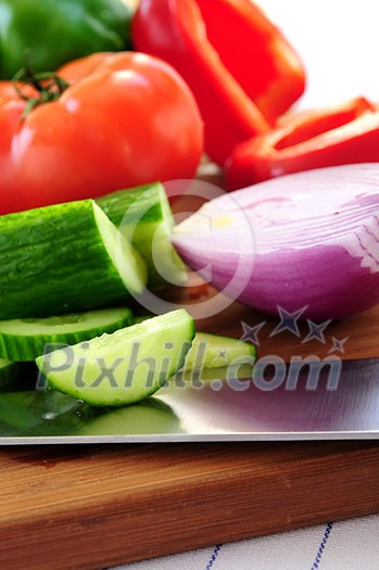 Fresh garden vegetables on cutting board - ingredients for a salad Fresh garden vegetables on cutting board - ingredients for a salad