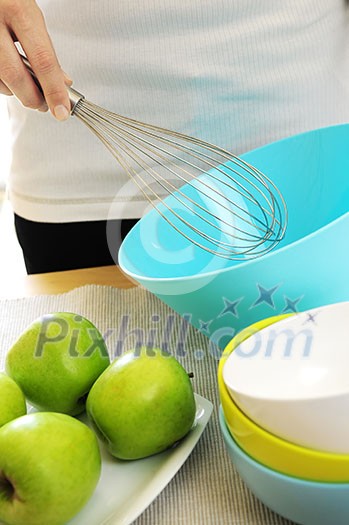 Woman preparing food with whisk and bowl Woman preparing food with whisk and bowl